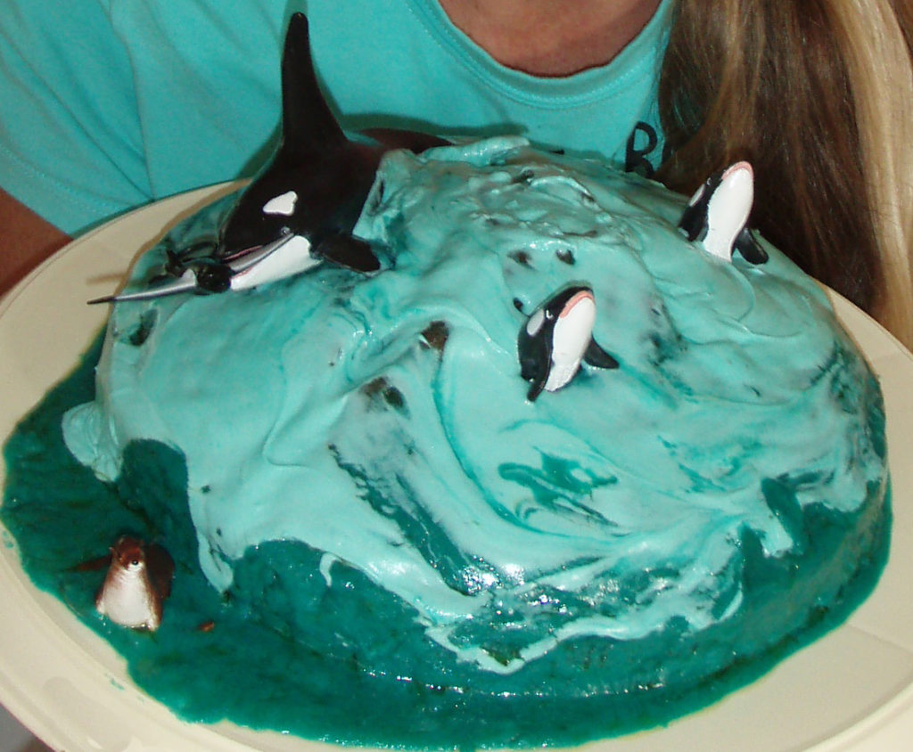 Birthday cake with orca decoration and blue icing