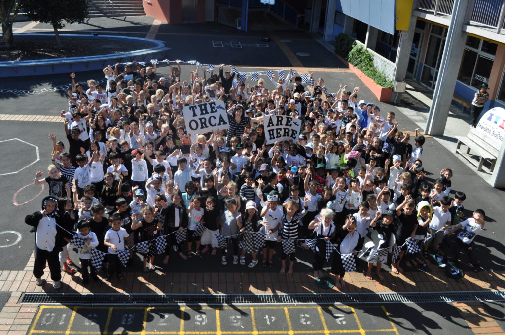 Youth and kids celebrate an orca theme at Point View School, New Zealand.